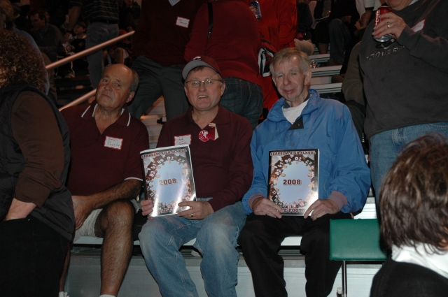 Brad Ruggles, Jack Trumble, and Jeff Pardee holding 2008 Football Programs.